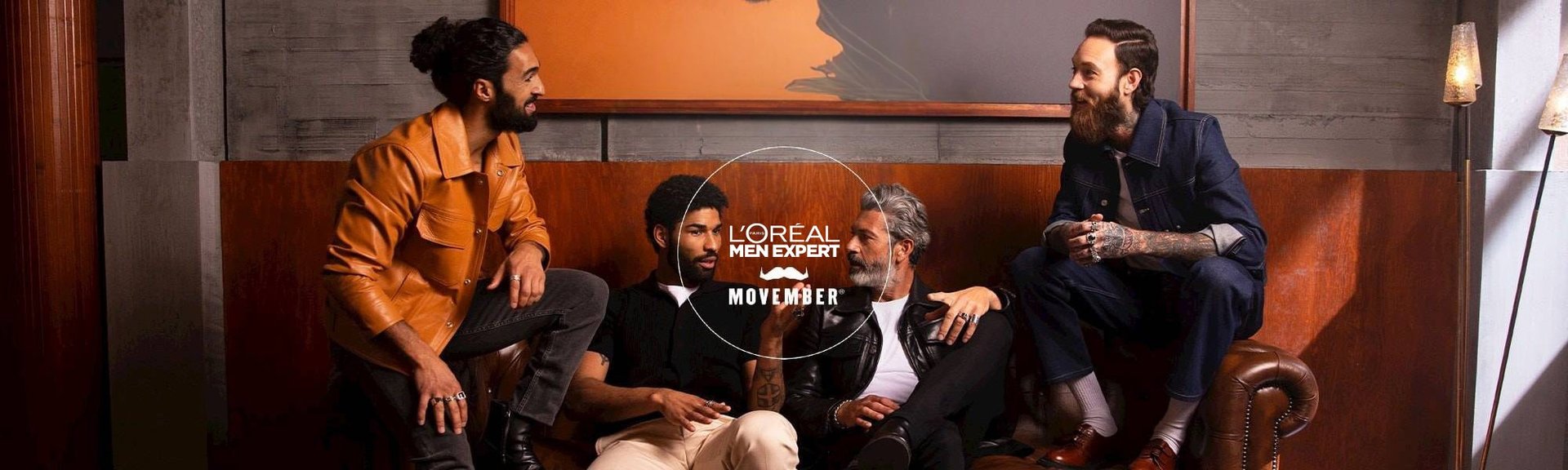 Eine Runde Männer mit Bärten & das L'Oréal MenExpert Movember Logo