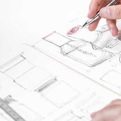 Eine Person färbt die Skizzen, die Produktverpackungen von L'Oréal darstellen