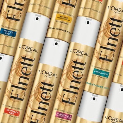 Verschiedene Elnett Haarsprays nebeneinander liegend