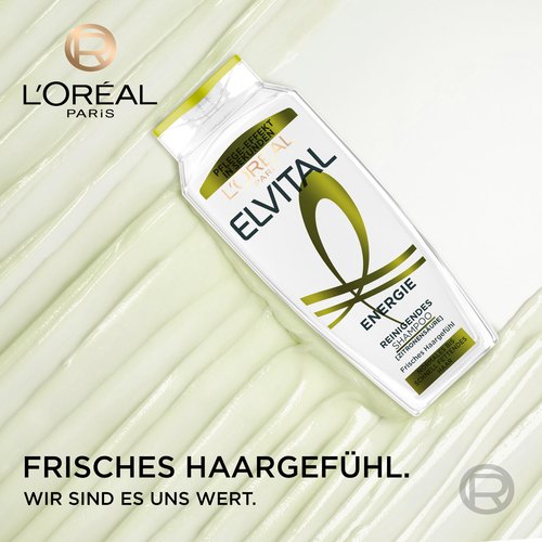 Schräg liegende Elvital Energie Shampoo-Flasche auf einer hellgrünen Gel-Textur mit dem L'Oréal Paris Logo und dem Slogan „Frisches Haargefühl. Wir sind es uns wert.“.