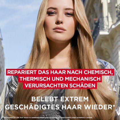 Porträt einer blonden Frau vor Pariser Kulisse mit der Aufschrift: „Repariert das Haar nach chemisch, thermisch und mechanisch verursachten Schäden. Belebt extrem geschädigtes Haar wieder.“