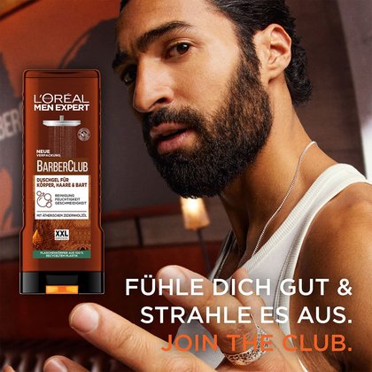 Braunes Fläschchen mit Barber Club Bartöl neben der Pappverkackung