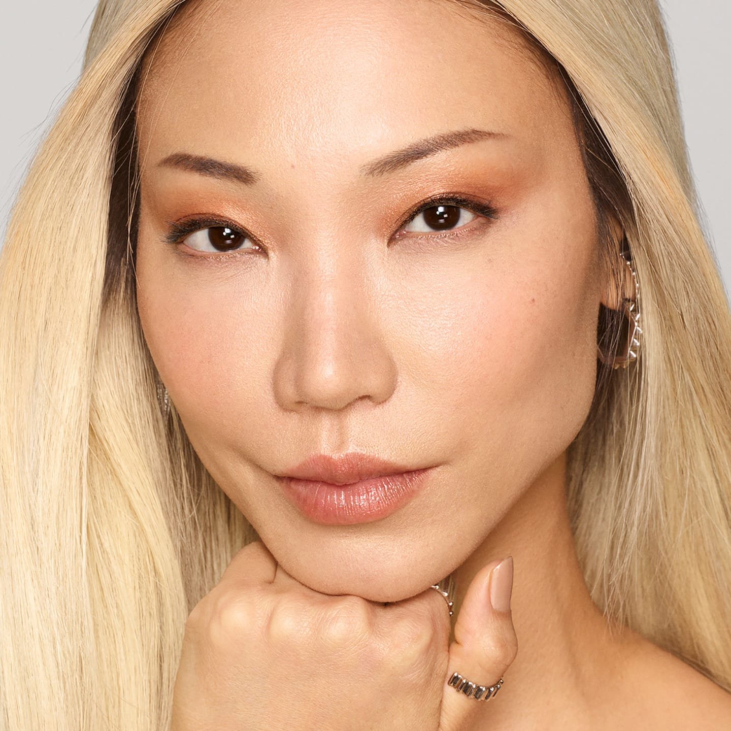 Eine junge Frau mit langen blond gefärbten Haaren nach Anwendung des Concealer 4D Light Medium