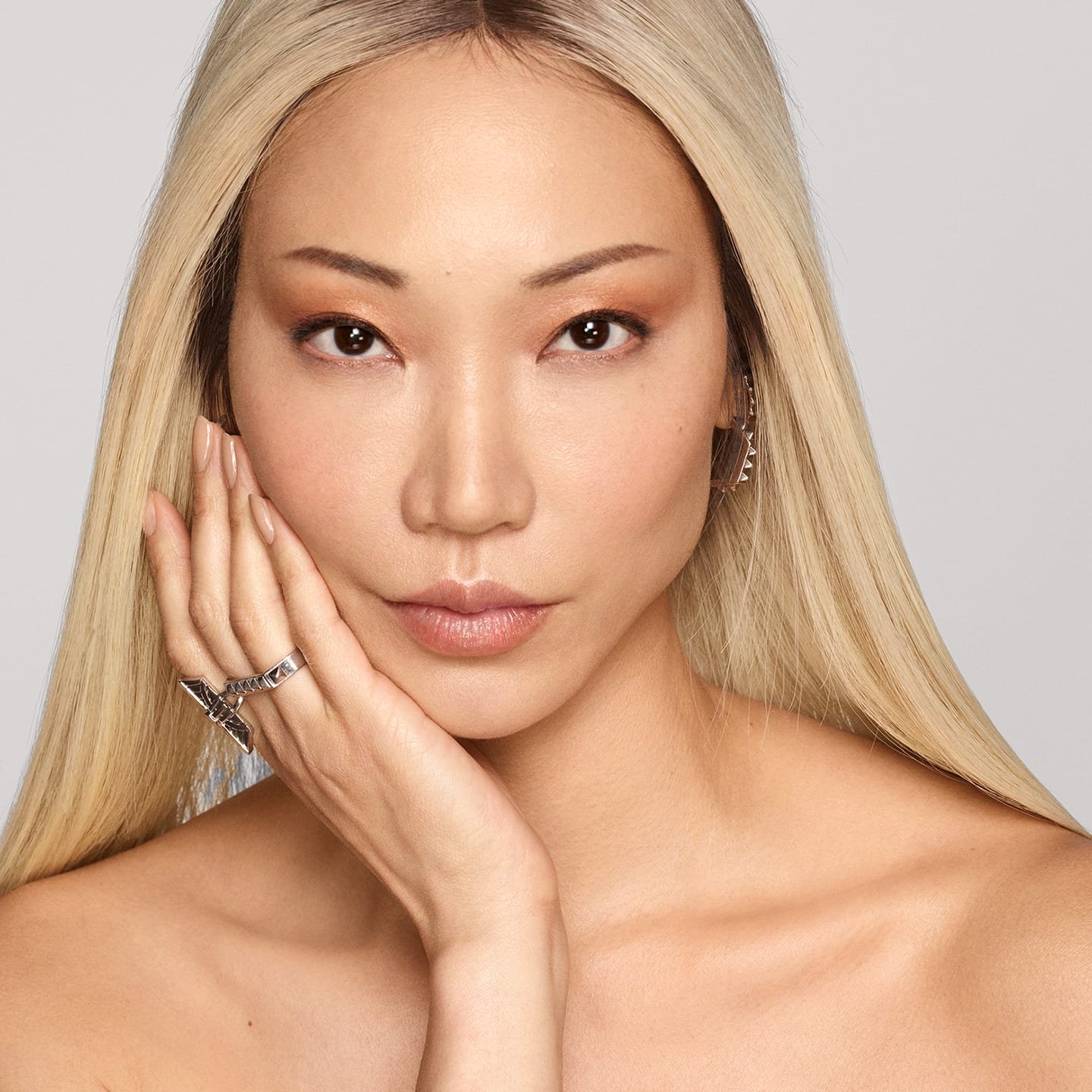 Eine junge Frau mit langen blond gefärbten Haaren nach Anwendung des Concealer 4N Light Medium